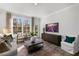 Bright living room with large window, stylish furniture, and modern entertainment center at 602 Andrade Dr, Fuquay Varina, NC 27526