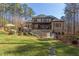 Expansive backyard featuring manicured lawn, mature trees, a pool, and an outdoor seating area at 6105 Valencia Ct, Raleigh, NC 27614