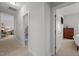 This hallway has neutral paint and carpet at 6301 Kayton St, Raleigh, NC 27616