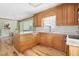 Bright kitchen featuring granite countertops, wooden cabinets, and modern appliances at 634 Hillhaven Ter, Roxboro, NC 27573