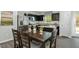 Cozy kitchen and dining area with stainless steel appliances, dark wood table, and views to outside at 64 Delcarso Ct, Lillington, NC 27546