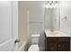 Clean bathroom with a tub, updated fixtures, and a well-lit vanity area at 684 Wickham Ridge Rd, Apex, NC 27539