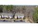 A three-story townhome community features well-manicured landscaping, parking, and forest views at 684 Wickham Ridge Rd, Apex, NC 27539