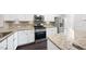 Bright kitchen features stainless steel appliances and sleek granite countertops at 684 Wickham Ridge Rd, Apex, NC 27539
