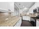 Bright kitchen features granite countertops, stainless steel appliances, and white cabinets at 684 Wickham Ridge Rd, Apex, NC 27539