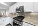 Modern kitchen with stainless steel appliances, granite countertops, and ample storage at 684 Wickham Ridge Rd, Apex, NC 27539