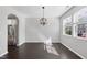 Sunlit living room featuring hardwood floors, neutral walls, and geometric pendant lighting at 684 Wickham Ridge Rd, Apex, NC 27539