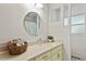 Cozy bathroom features a round mirror, soft lighting, and charming decor at 703 Caswell Rd, Chapel Hill, NC 27514