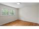 Bright bedroom with hardwood floors and ample natural light from the window at 703 Caswell Rd, Chapel Hill, NC 27514
