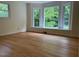 Bright bedroom featuring natural light from large windows and light hardwood flooring at 703 Caswell Rd, Chapel Hill, NC 27514