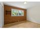 Neutral bedroom featuring brick accent wall, closet and large window at 703 Caswell Rd, Chapel Hill, NC 27514