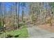 Long driveway leading to the home, bordered by trees and foliage and the house number posted on the mailbox at 703 Caswell Rd, Chapel Hill, NC 27514