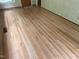 Spacious empty room featuring new flooring, wood paneling, and natural light at 703 Caswell Rd, Chapel Hill, NC 27514