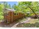 Brick home with a stone walkway and garden featuring blooming flowers and lush greenery at 703 Caswell Rd, Chapel Hill, NC 27514