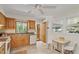 Practical kitchen with wooden cabinets, white appliances, and a cozy dining area at 703 Caswell Rd, Chapel Hill, NC 27514
