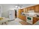 Well-lit kitchen with wood cabinetry, featuring modern appliances and ample counter space at 703 Caswell Rd, Chapel Hill, NC 27514
