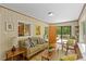 Comfortable living room featuring hardwood floors, a view of the kitchen, and access to outdoor deck at 703 Caswell Rd, Chapel Hill, NC 27514