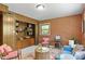 Cozy living room featuring exposed brick wall and built in bookcases at 703 Caswell Rd, Chapel Hill, NC 27514