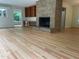 Living room with a fireplace, hardwood flooring, and built in shelving at 703 Caswell Rd, Chapel Hill, NC 27514