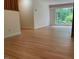 Open living space features hardwood floors and a large window with a view of the surrounding greenery at 703 Caswell Rd, Chapel Hill, NC 27514