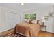 Bright bedroom features a large window, wood floors, and ample closet space at 703 Caswell Rd, Chapel Hill, NC 27514