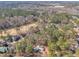 Aerial view of a home with mature trees and landscaping in a quiet neighborhood at 723 Chelsea Dr, Sanford, NC 27332