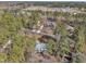 Aerial view of a brick home with mature trees and landscaping in a quiet neighborhood at 723 Chelsea Dr, Sanford, NC 27332