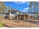 Spacious backyard featuring a deck, brick foundation, and mature trees for privacy at 723 Chelsea Dr, Sanford, NC 27332