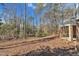 Natural backyard with deck and mature trees providing a serene, wooded view at 723 Chelsea Dr, Sanford, NC 27332