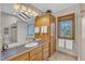 Bright and airy bathroom with skylights, wood cabinetry, and plenty of storage space at 723 Chelsea Dr, Sanford, NC 27332