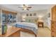 Well-lit bedroom features a ceiling fan, large window, and two bedside tables with lamps at 723 Chelsea Dr, Sanford, NC 27332