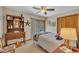 Cozy bedroom with wooden floors, a ceiling fan, and natural light from a sliding door to the outside at 723 Chelsea Dr, Sanford, NC 27332