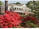 View of a clubhouse with a wrap-around porch and landscaping at 723 Chelsea Dr, Sanford, NC 27332