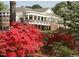 Stunning clubhouse with a red-brick facade, a portico, and beautiful landscaping at 723 Chelsea Dr, Sanford, NC 27332