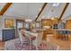 Dining area with skylight, wooden beams, slider door and flows into a stunning modern kitchen at 723 Chelsea Dr, Sanford, NC 27332