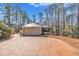 Charming home exterior featuring brick driveway and attached garage in a wooded setting at 723 Chelsea Dr, Sanford, NC 27332