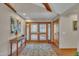 Inviting foyer featuring hardwood floors, wooden double doors, and decorative rug at 723 Chelsea Dr, Sanford, NC 27332