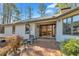 Charming home entrance with brick patio, seating, and beautiful double doors at 723 Chelsea Dr, Sanford, NC 27332