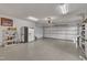 Spacious garage with epoxy flooring, white walls and lighting, and garage door with automatic door opener at 723 Chelsea Dr, Sanford, NC 27332
