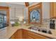 Kitchen sink with granite counter, stainless fixtures, and tile backsplash with a window view at 723 Chelsea Dr, Sanford, NC 27332