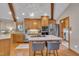 Bright kitchen features wood cabinets, stainless steel appliances, island, and wood beam vaulted ceiling at 723 Chelsea Dr, Sanford, NC 27332