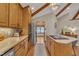 Bright kitchen features wood cabinets, stainless steel appliances, island with cooktop, and view of breakfast nook at 723 Chelsea Dr, Sanford, NC 27332