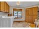 Spacious laundry room with washer, dryer, lots of cabinet space, and window with wooded view at 723 Chelsea Dr, Sanford, NC 27332