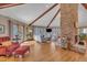 Bright living room featuring high ceilings, wood beams, fireplace, and large windows at 723 Chelsea Dr, Sanford, NC 27332