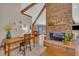 Living room features brick fireplace, vaulted ceiling with wood beams, desk, and views to other living spaces at 723 Chelsea Dr, Sanford, NC 27332