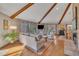 Spacious living room with vaulted ceiling, wood beams, fireplace, and plenty of natural light at 723 Chelsea Dr, Sanford, NC 27332