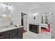 Elegant bathroom with double vanity sinks, granite countertop, and access to the bedroom at 7525 Poplar Meadow Ln, Raleigh, NC 27616