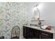 Delightful half bathroom featuring floral wallpaper, classic vanity, and a bright, airy feel at 7525 Poplar Meadow Ln, Raleigh, NC 27616