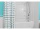 Clean, white tiled tub and shower featuring modern fixtures and a bright, airy feel at 7525 Poplar Meadow Ln, Raleigh, NC 27616