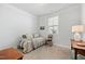 Comfortable bedroom with a daybed, neutral carpet, and natural light from the window at 7525 Poplar Meadow Ln, Raleigh, NC 27616